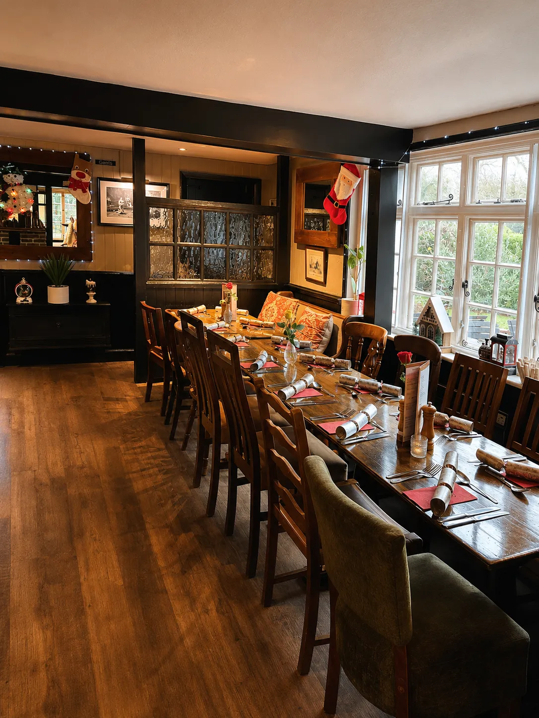 The main dining room with wood floors and beams
